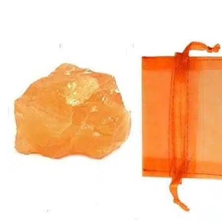 Orange Calcite Rough 1 Orange Calcite Rough, natural orange calcite mineral with a raw and unpolished appearance beside an orange cloth pouch for storage or gifting.