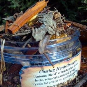 Fall Casting Herbs, aromatic herbal blend in a glass jar with dried herbs and twigs on top.