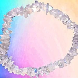 Crown Chakra 31 Selenite Chip Bracelet, handmade jewelry featuring irregularly shaped, translucent white selenite stones arranged in a circular bracelet on a pastel rainbow background.