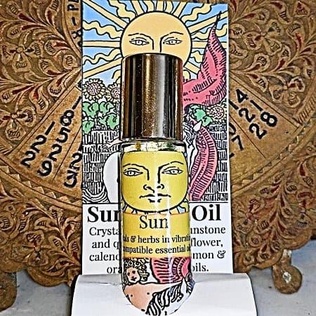 Goddess Gift Set 5 Goddess Gift Set, a bottle of essential oil with a colorful and artistic label featuring a woman's face and sun imagery.